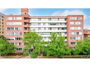 This attractive brick apartment building features large windows and mature trees in a desirable urban location at 1196 N Grant St # 705, Denver, CO 80203
