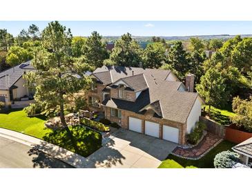 Beautiful brick home with a three-car garage and mature trees in a well-maintained neighborhood at 5344 E Otero Dr, Centennial, CO 80122