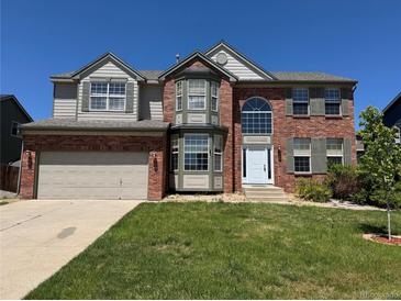 Charming two-story brick home with a well-manicured lawn, attached garage, and lovely architectural details at 1251 N Burlington Dr, Castle Rock, CO 80104