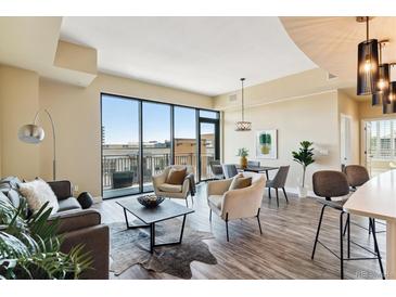 Open living area with hardwood floors, city view, and ample natural light at 2990 E 17Th Ave # 604, Denver, CO 80206