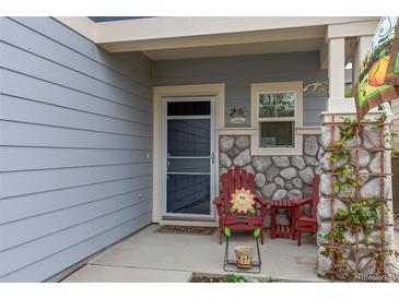 Charming front porch with stone accents, welcome mat, and cozy seating creates a warm entrance at 6210 Wescroft Ave, Castle Rock, CO 80104