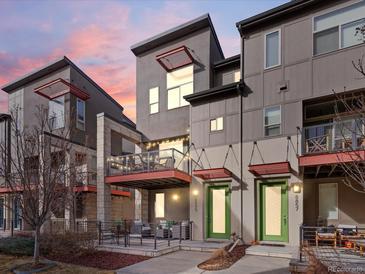 Modern townhomes with unique architectural details and private balconies under a colorful sunset at 8855 E 55Th Ave, Denver, CO 80238