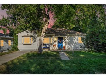 Charming home with a well-maintained lawn, inviting walkway, mature shade trees, and a cozy front porch at 60 Vrain St, Denver, CO 80219
