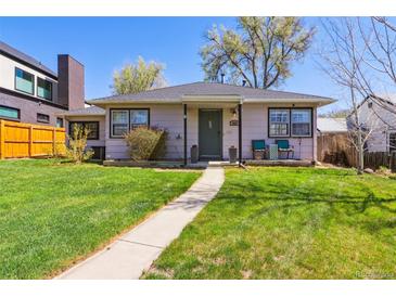 Charming single-story home with a well-manicured lawn and inviting walkway leading to the front door at 1624 S Elizabeth St, Denver, CO 80210