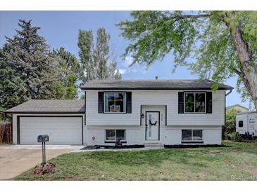 Charming two-story home featuring a well-maintained front yard and attached garage at 5945 W 86Th Ave, Arvada, CO 80003