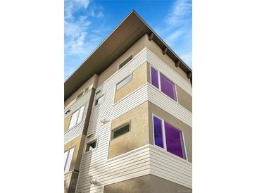 Modern exterior with horizontal siding and ample windows for natural light on a partly cloudy day at 1304 Snowberry # 203, Louisville, CO 80027