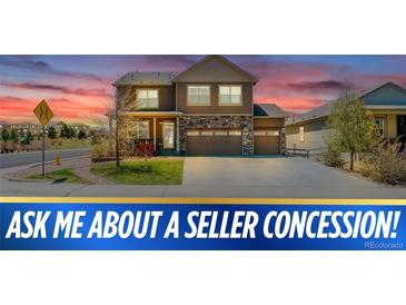 Charming two-story home featuring a stone-accented facade, a two-car garage, and professional landscaping at 2177 Shadow Creek Dr, Castle Rock, CO 80104