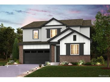 Inviting two-story home with a brick-accented garage and well-manicured front yard at 14075 Bunny Hop Ln, Parker, CO 80134