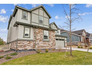 Beautiful two-story home featuring stone and siding, complemented by a well-manicured lawn at 7173 S Shady Grove Ct, Aurora, CO 80016