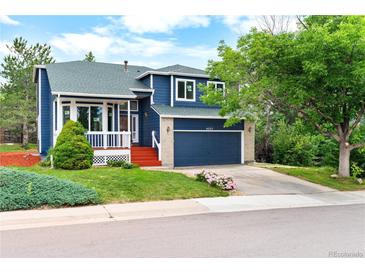 Charming two-story home featuring a well-maintained lawn and a two car garage at 4257 S Andes Way, Aurora, CO 80013