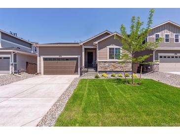 Charming single-Gathering home featuring a well-manicured lawn and a two-car garage at 18951 E 96Th Pl, Commerce City, CO 80022