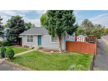 Charming home featuring a well-maintained lawn, mature trees, and a light blue front door at 103 S Zenobia St, Denver, CO 80219