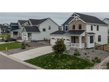Charming two-story home featuring stone accents, a covered porch, and a well-manicured front yard at 1143 Williams Loop, Elizabeth, CO 80107