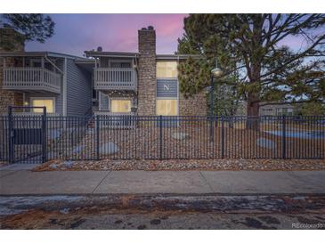 Charming condo with a stone facade, private balconies and a decorative iron fence for enhanced curb appeal at 4400 S Quebec St # 101N, Denver, CO 80237