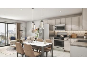 An open-concept kitchen and dining area features stainless steel appliances and modern lighting at 433 N Havana # 308, Aurora, CO 80010