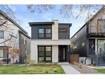 Modern two-story home with a combination of stone and dark siding, plus manicured front lawn at 3646 Quivas St, Denver, CO 80211