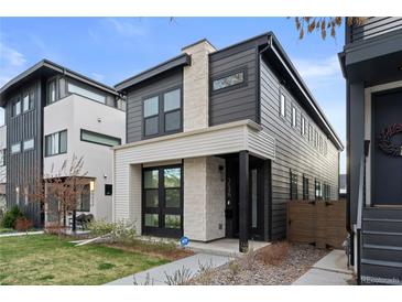 Contemporary two-story home with a modern design, featuring a combination of gray siding and stone accents at 3646 Quivas St, Denver, CO 80211