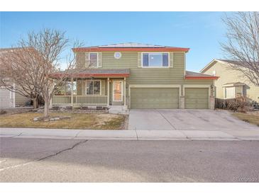 Charming two-story home boasts a well-maintained lawn, mature trees, and a spacious three-car garage at 6348 Westview Cir, Parker, CO 80134