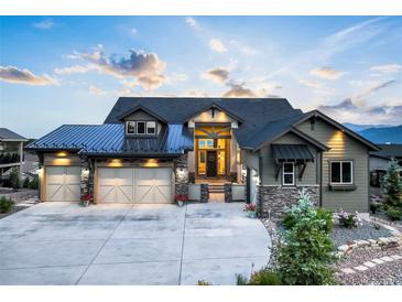 Beautiful home featuring a three car garage and manicured landscaping at 16486 Florawood Pl, Monument, CO 80132