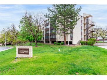 Well-maintained condo building with lush green lawn and mature trees in a desirable community at 3470 S Poplar St # 401, Denver, CO 80224