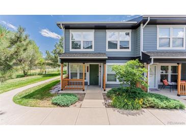 Charming two-story townhouse with a covered front porch and well-maintained landscaping at 1459 S Pierce St, Lakewood, CO 80232