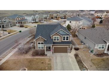 Charming two-story home in a Gathering-friendly community with a well-maintained lawn at 5404 Fawn Ridge Way, Castle Rock, CO 80104