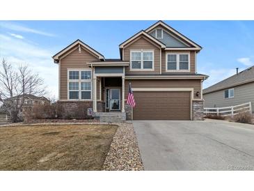 Charming two-story home with a two-car garage and well-manicured front yard at 5404 Fawn Ridge Way, Castle Rock, CO 80104