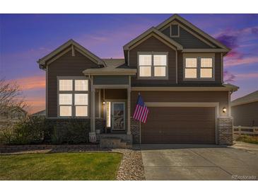 Inviting two-story home featuring a well-manicured lawn and an attached two-car garage at 5404 Fawn Ridge Way, Castle Rock, CO 80104