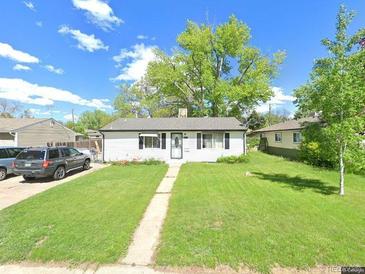 Charming single-story home with well-maintained lawn and a classic design at 3920 S Inca St, Englewood, CO 80110