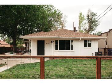 Charming home featuring a well-manicured lawn, a white brick exterior, and a cozy front porch with seating at 4422 W 27Th Ave, Denver, CO 80212