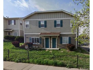 Inviting townhome exterior showcasing dark green shutters and well-maintained landscaping at 4582 W Alameda Ave, Denver, CO 80219