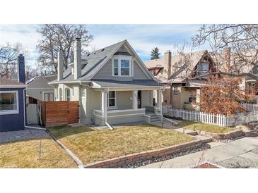 Charming two-story home with a well-manicured lawn, inviting front porch, and classic architectural details at 3825 Tejon St, Denver, CO 80211
