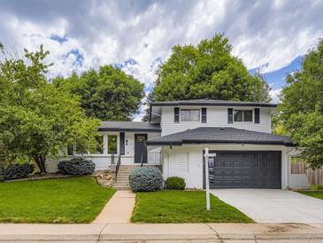 Charming two-story home with lush landscaping, inviting entrance and well-maintained front yard at 3793 S Sebring Ct, Denver, CO 80237