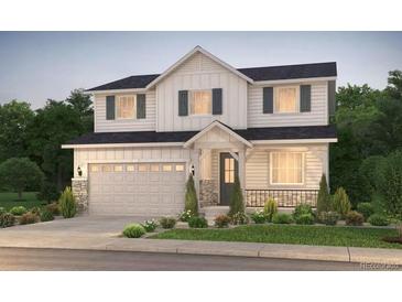 Charming two-story home with a two-car garage, inviting front porch and manicured landscaping at 2145 S Ider Way, Aurora, CO 80018
