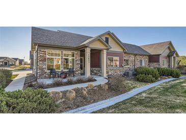 Charming single-story home featuring a stone facade, covered porch, and well-maintained landscaping at 12625 Madison Way, Thornton, CO 80241