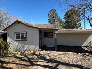 Cozy single-story home features a covered parking area and low-maintenance front yard at 1536 Trenton St, Denver, CO 80220