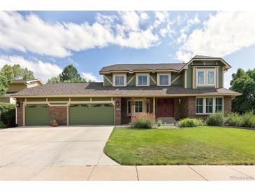 Charming two-story home with a three-car garage and well-manicured lawn at 1892 W Kettle Ave, Littleton, CO 80120