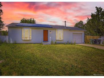 Charming single-story home featuring solar panels, a well-maintained lawn, and a welcoming front entrance at 10895 Fairfax Way, Thornton, CO 80233