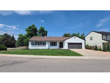 Charming single-story home with a well-manicured lawn and a freshly painted exterior at 10297 W Crestone Mtn, Littleton, CO 80127