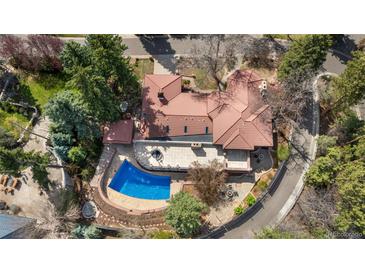 Stunning aerial view of a home with a red tile roof, a pool, and an outdoor patio at 2111 E Alameda Ave, Denver, CO 80209