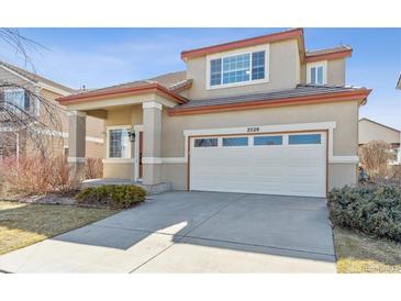 Inviting two-story home featuring a spacious two-car garage and well-maintained front yard at 2520 E 127Th Ave, Thornton, CO 80241