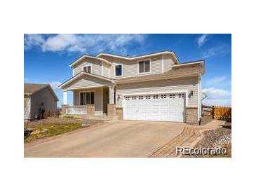 Charming two-story home with a two car garage and inviting front porch at 9799 Falcon Ln, Littleton, CO 80125