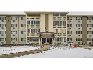 Apartment building exterior, featuring a snow-covered walkway and festive decorations at 9335 E Center Ave # 4B, Denver, CO 80247