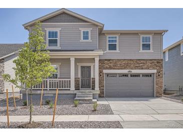 Charming two-story home featuring stone accents and a covered front porch at 15276 Fillmore St, Thornton, CO 80602