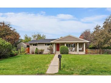 Charming single-story home featuring a covered porch and lush front lawn at 395 Zephyr St, Lakewood, CO 80226