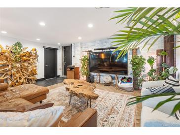 Inviting living room boasts stylish décor, including a unique wood coffee table and ample natural light at 1203 24Th St, Denver, CO 80205