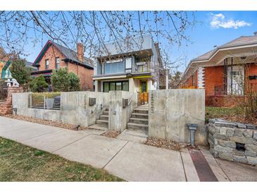 Modern exterior featuring a concrete wall, xeriscaping, and architectural design with a yellow trim at 2223 W 34Th Ave, Denver, CO 80211
