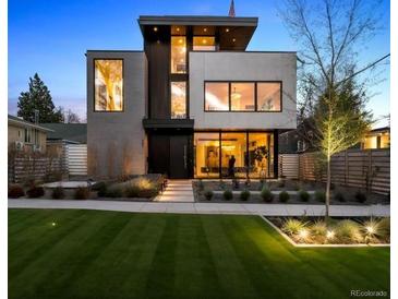 Stunning modern home featuring manicured lawn and beautiful landscaping for great curb appeal at 562 Steele St, Denver, CO 80206