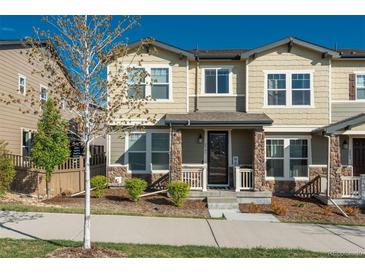 Charming two-story townhome with stone accents, inviting front porch, and well-manicured landscaping at 2907 Distant Rock Ave, Castle Rock, CO 80109