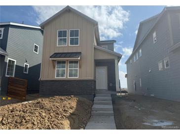 Newly built two-story home with a mix of modern materials and a welcoming entrance at 23772 E 33Rd Pl, Aurora, CO 80019